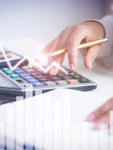 Accountant calculating profit with financial analysis graphs