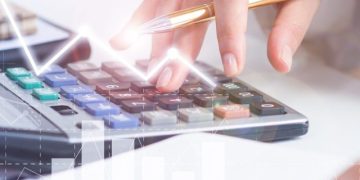 Accountant calculating profit with financial analysis graphs