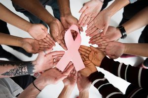 pessoas demonstrando suporte ao outubro rosa, sabendo os benefícios INSS mulheres com câncer.