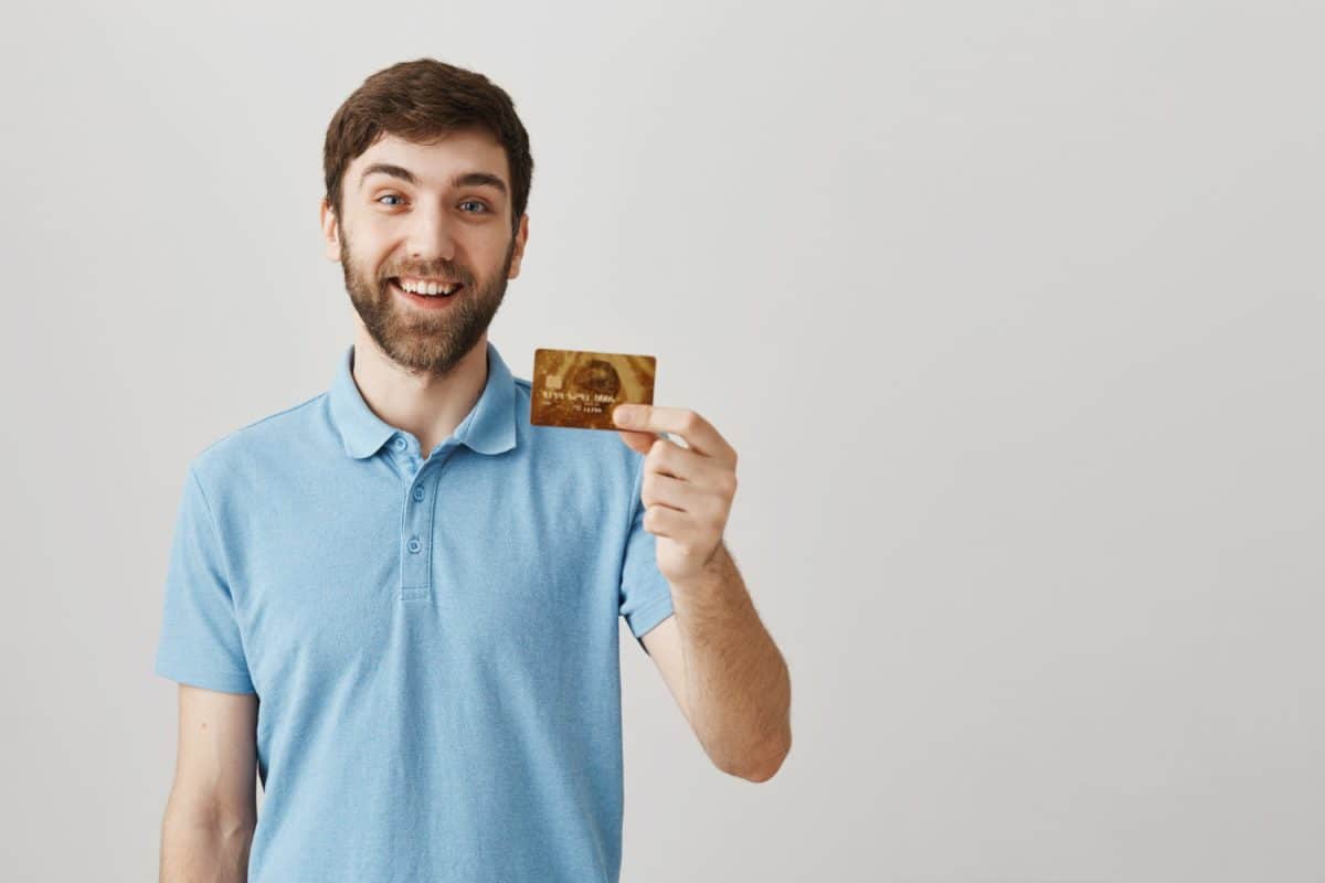 Hombre feliz com su tarjeta chile mastercard gold.