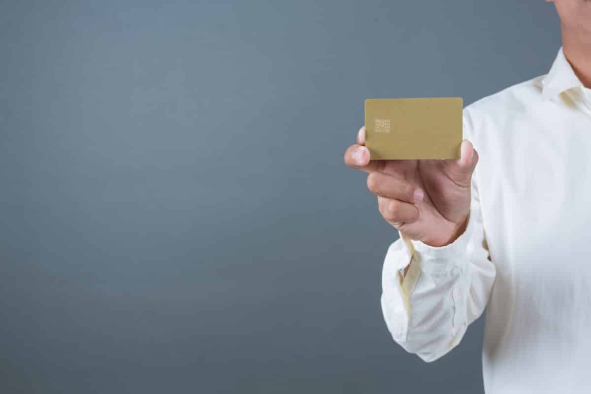 Someone holding a American Express Gold.