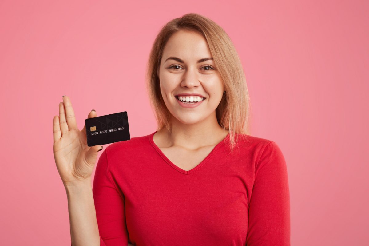 A happy woman with the Scotiabank American Express card.