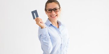 A happy woman with her VentureOne Rewards Credit Card