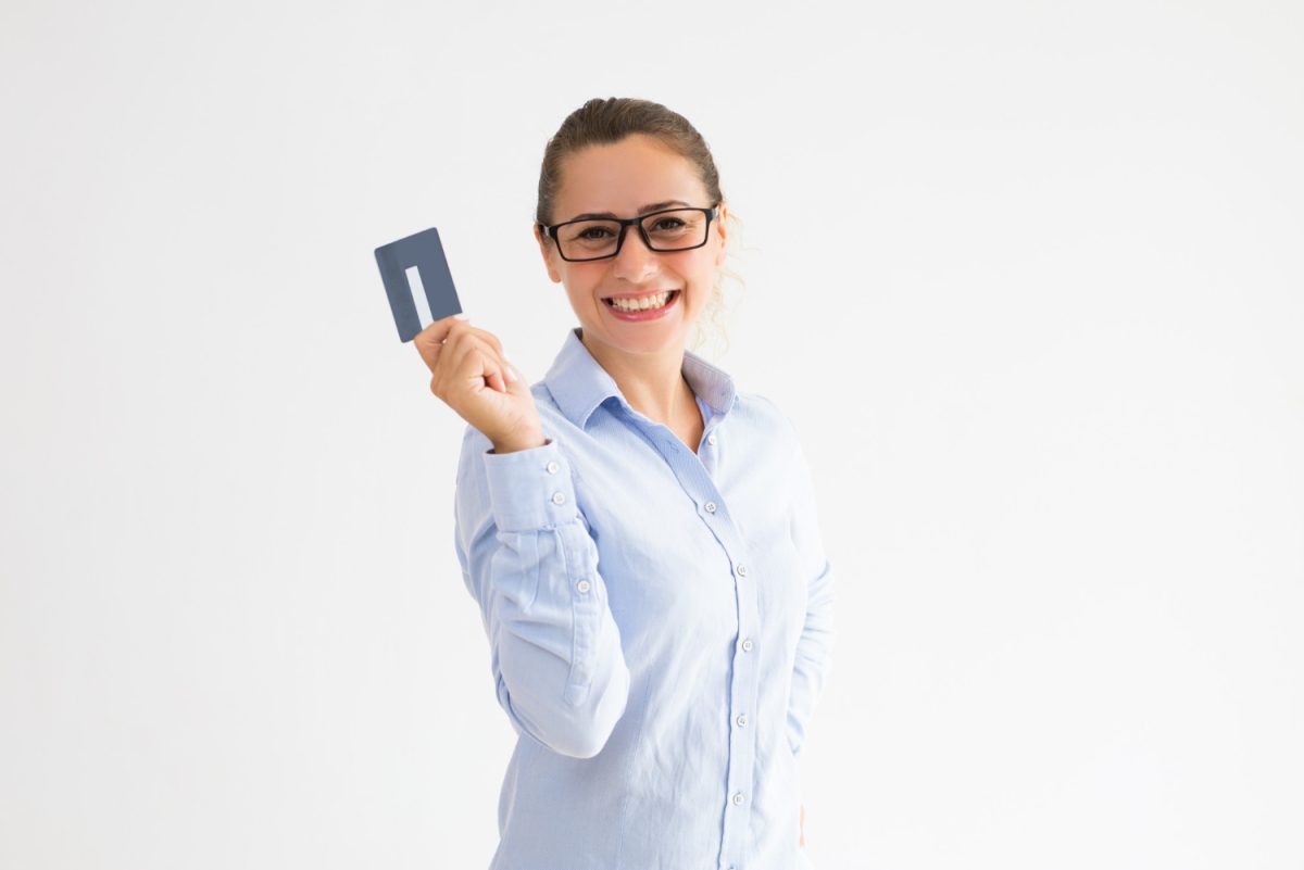 A happy woman with her VentureOne Rewards Credit Card