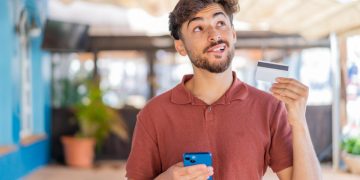 A guy learning how to apply for a credit card in Canadá and enjoying possibilities.