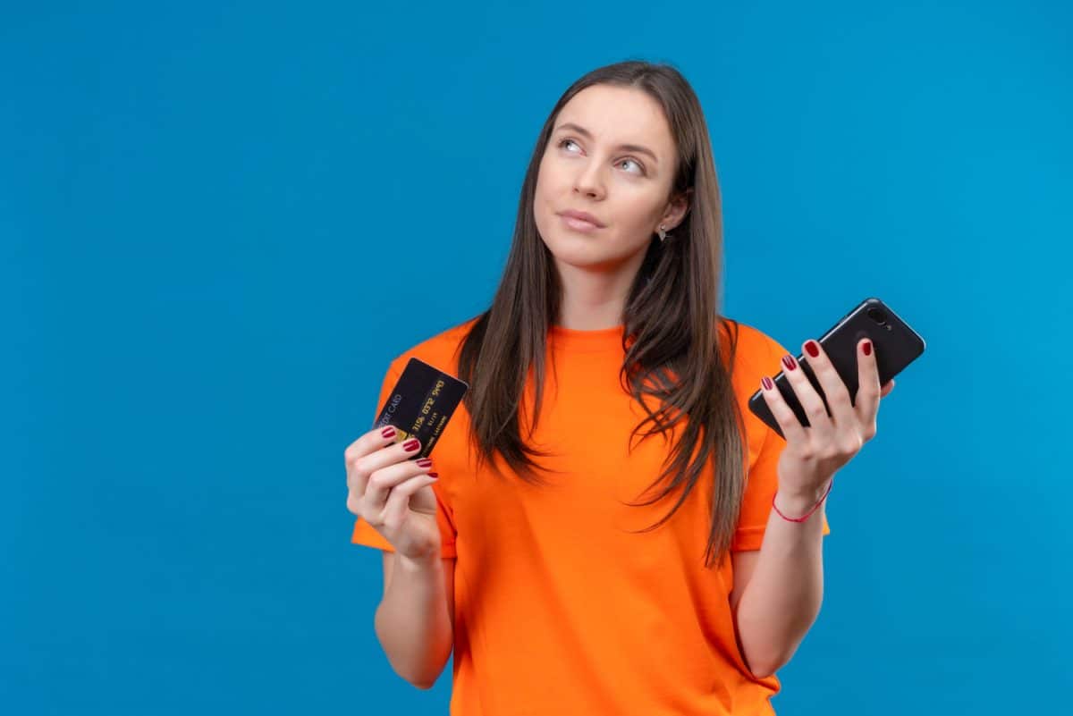 Woman choosing between Secured and Unsecured Credit Cards.