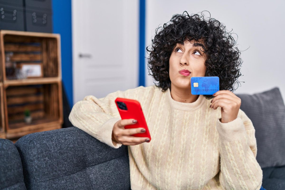 Woman choosing between the Types of Credit Cards.