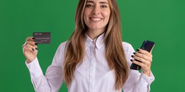 Woman holding her TD Cash Credit Card.
