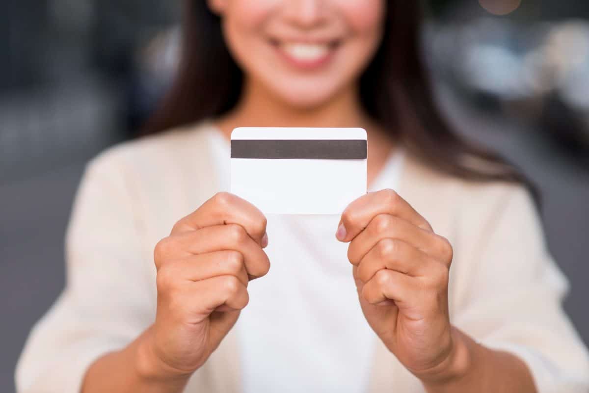 Woman holding her US Bank Cash Visa Signature.