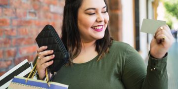 Woman thnking about use Multiple credit cards.