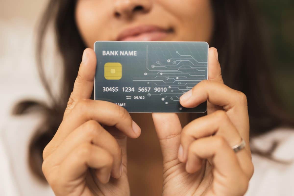 Woman showing your first credit card
