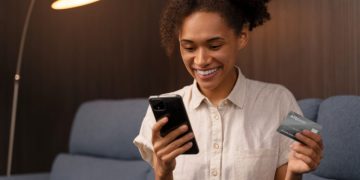 young woman opening a bank account online by phone