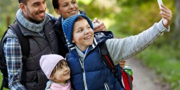 parents learning how to save money on family vacation.