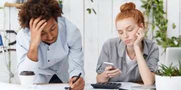 a sad couple with Credit card debt.